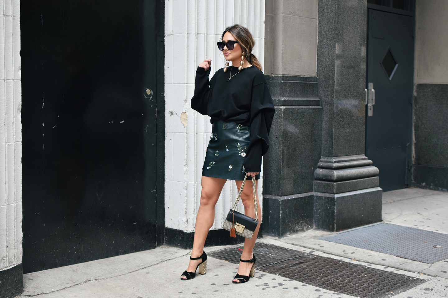 black-sweater-statment-leather-mini-skirt-dolce-and-gabanna-studded-block-heels-oversized-bubble-earring-nyfw-streetstyle