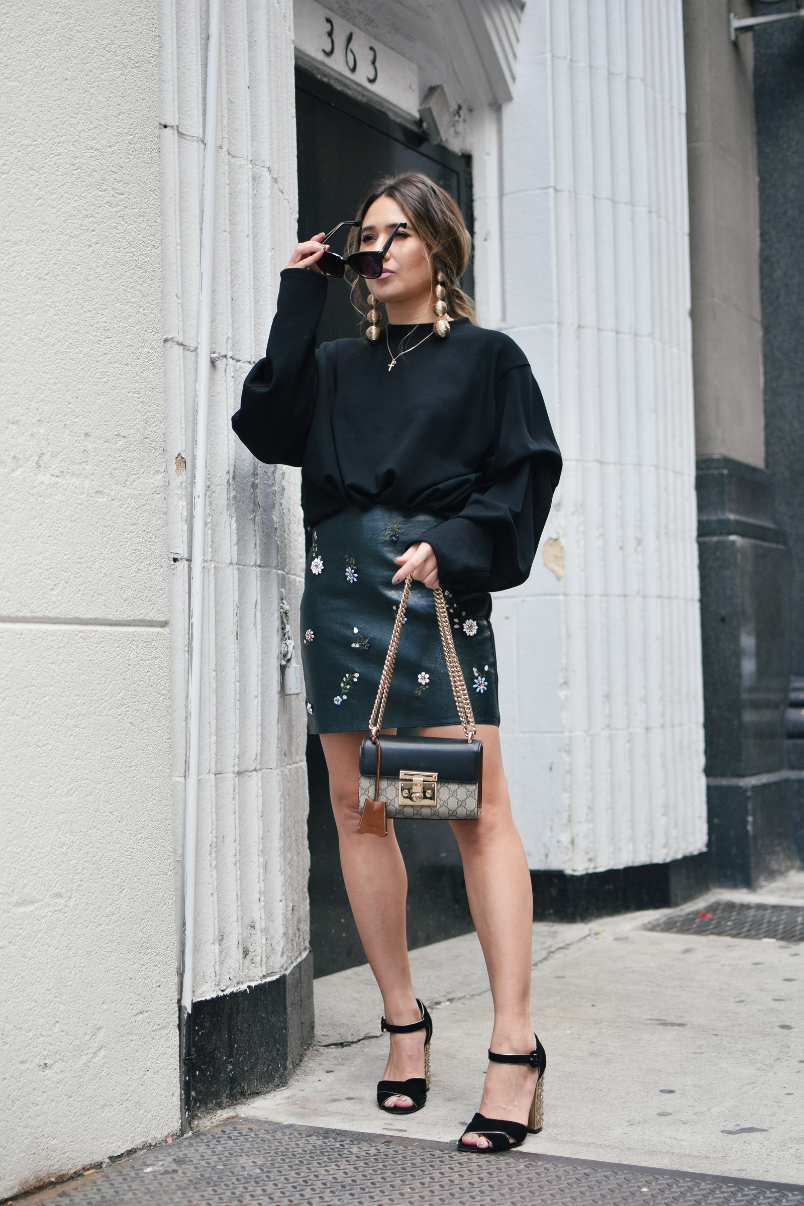 black-sweater-statment-leather-mini-skirt-dolce-and-gabanna-studded-block-heels-oversized-bubble-earring