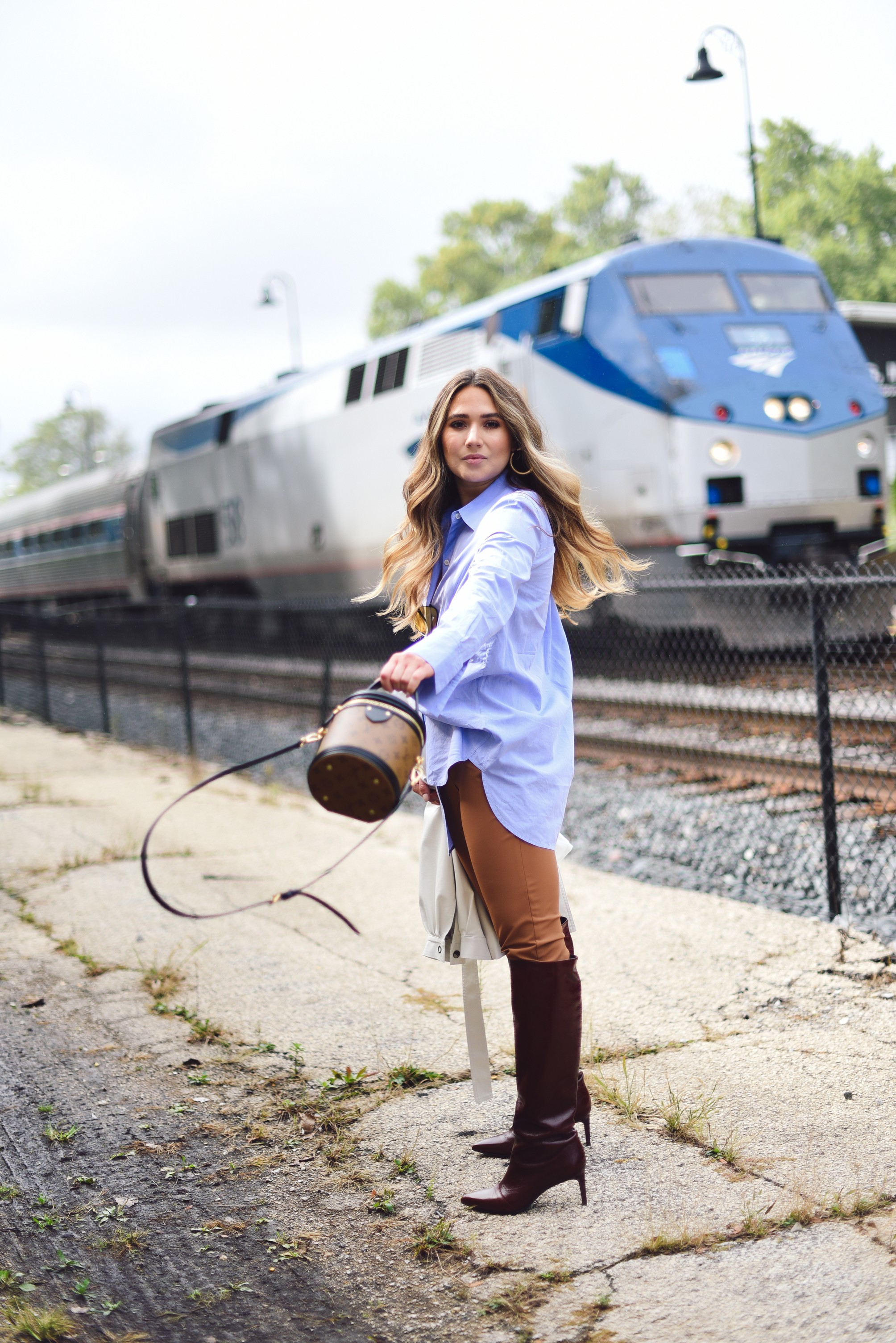 white-leather-jacket-button-up-shirt-blue-knee-high-maroon-boot-bucket-bag-fall-outfit-inspo-street-style-look