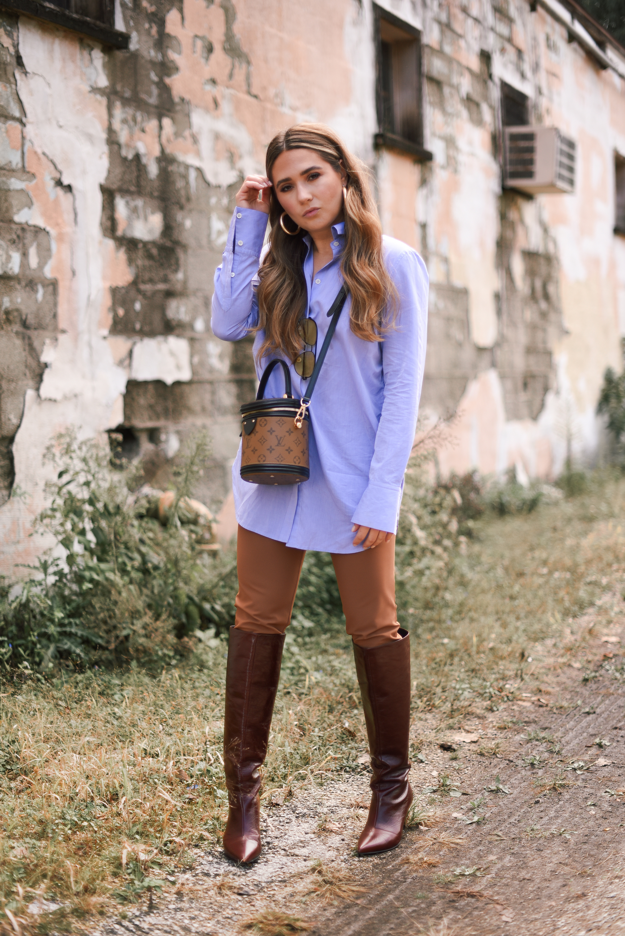 white-leather-jacket-button-up-shirt-blue-knee-high-maroon-boot-bucket-bag-fall-outfit-inspo-street-style-look