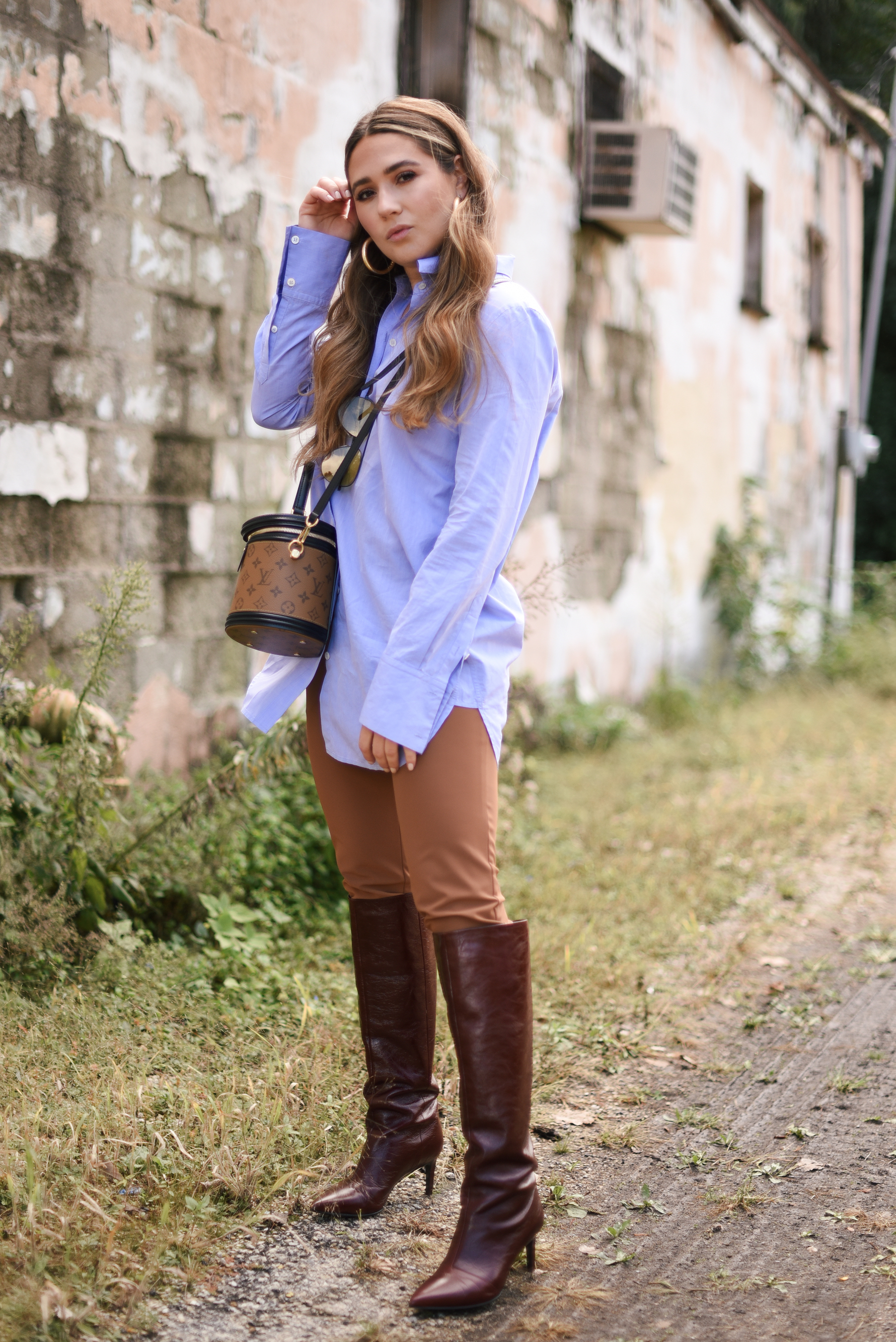 white-leather-jacket-button-up-shirt-blue-knee-high-maroon-boot-bucket-bag-fall-outfit-inspo-street-style-look